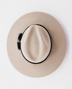 hat Top view of a stylish beige Panama hat on a pristine white background, showcasing elegance.